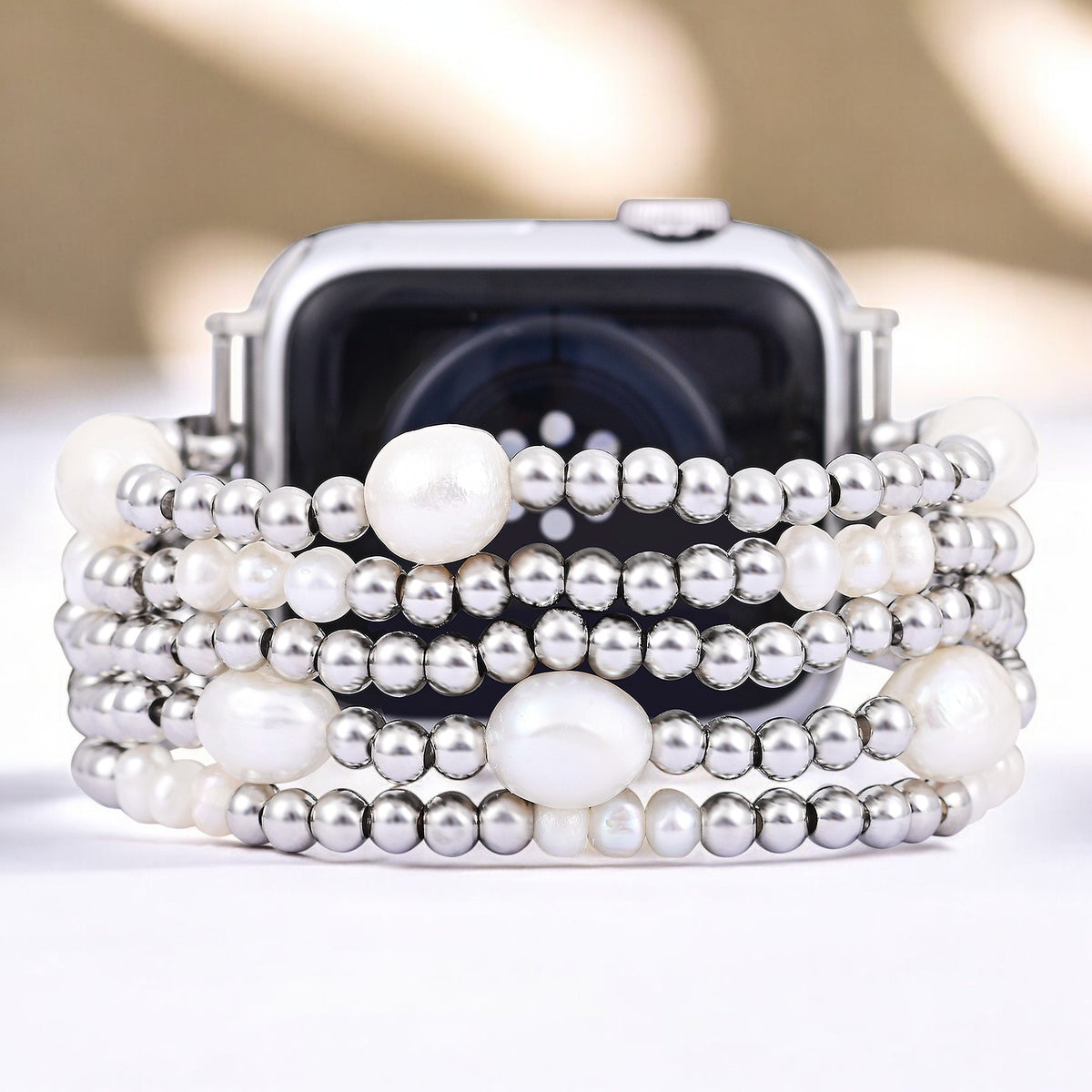 Parel- en zilverkleurige rekbare Apple Watch-band